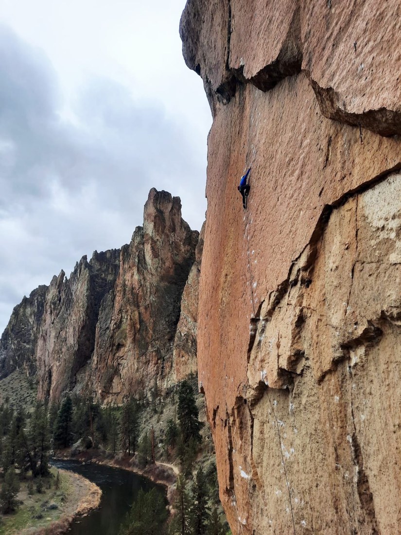 A climber ascending a steep rock wall