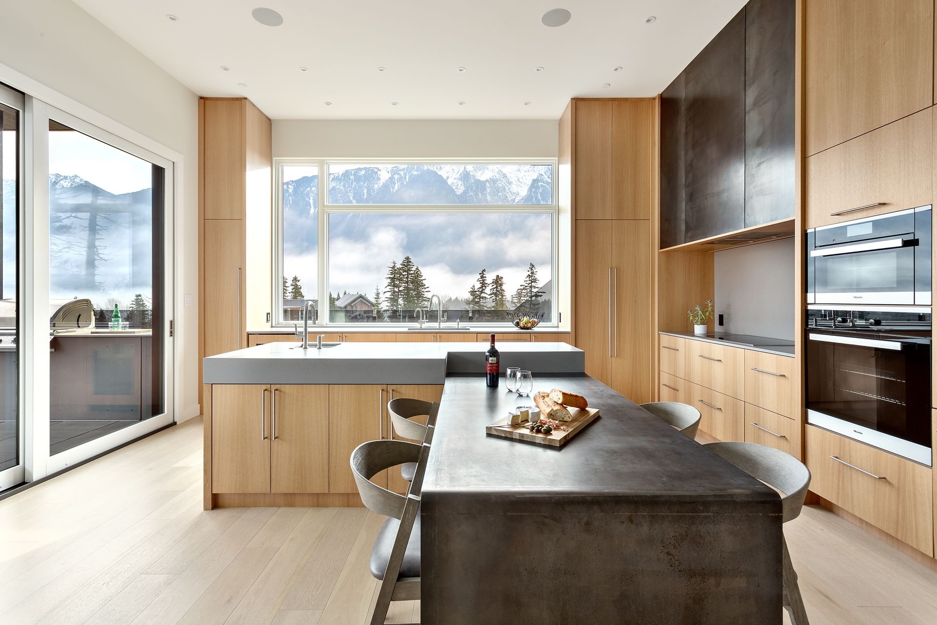 Newlines Contracting kitchen with wood cabinetry and mountain views